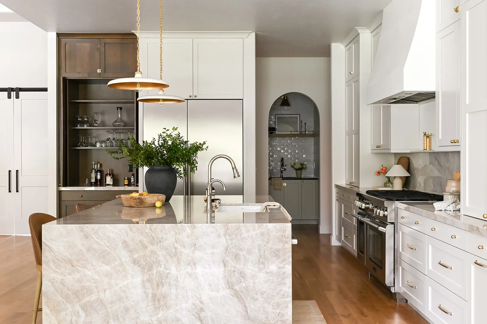 Kitchen built by Horn Building Co. with a stone waterfall island and warm oak floors